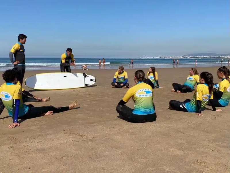 Group on beach with surfboards at Portugal Surf School